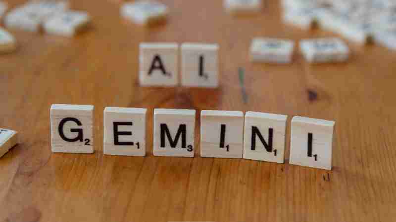 Scrabble tiles spell out the words 'Gemini' and 'AI' on a wooden surface, symbolizing technology and communication., tags: google und mistral - pexel